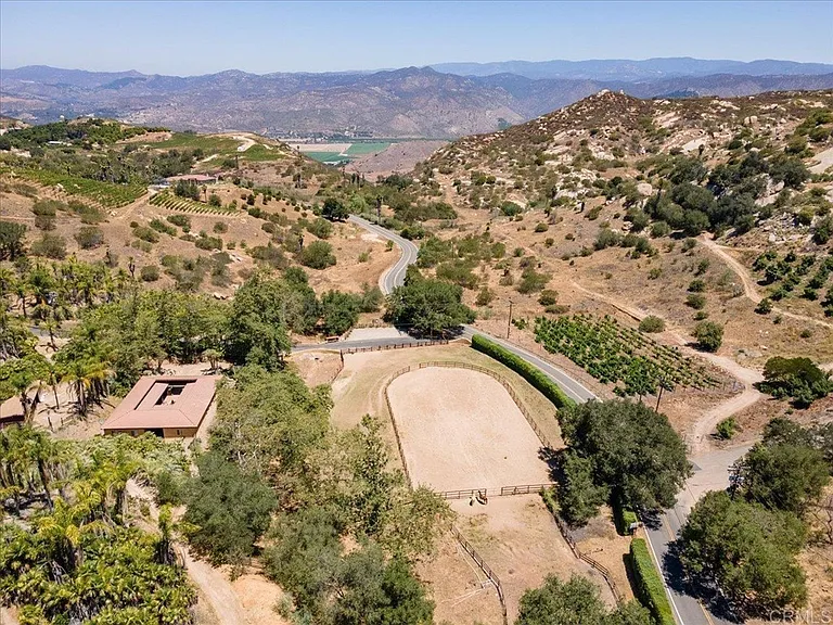 Birdseye view looking north. Stables on the left, arena on the right. San Pascual Valley and the San Dieguito River in the distance