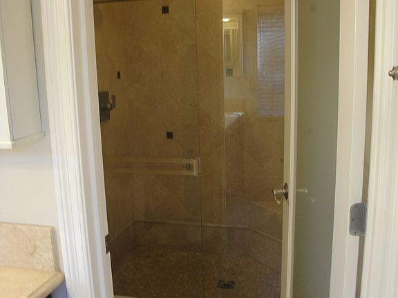 Master bedroom bath has stone shower and stone flooring and