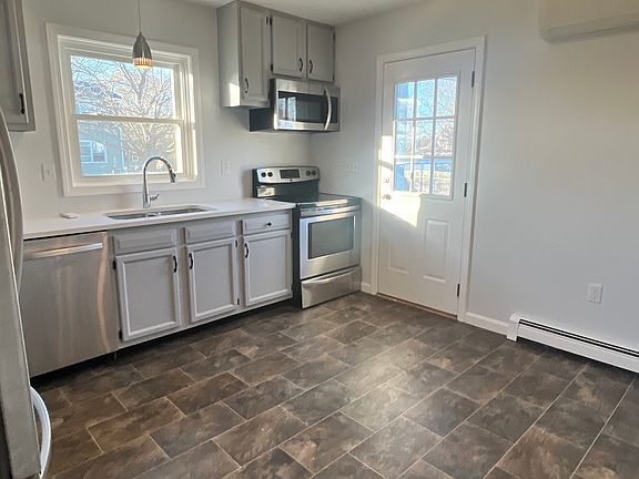 Side door with a mini-split system to the right of the door.