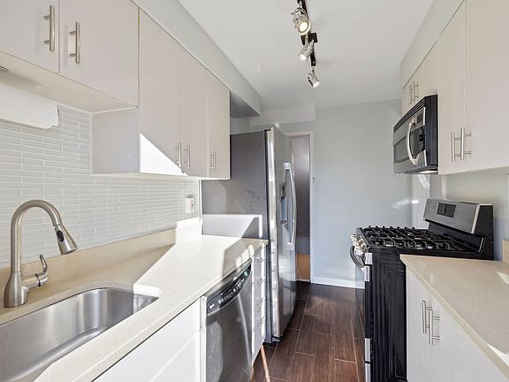 Kitchen (Main Level)- Stainless Steel Appliances, touchless faucet, solid surface countertops with tile backsplashes with full light door to backyard to allow plenty of natural light.