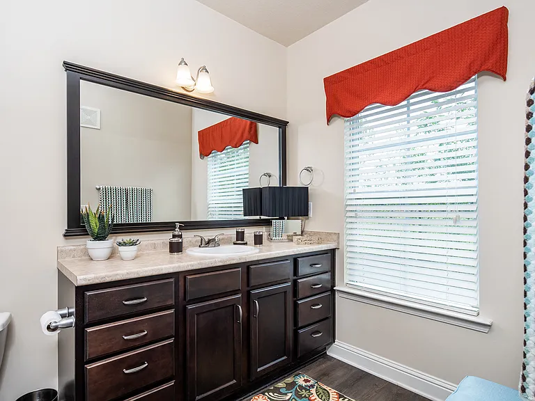 Bathroom with a window, sink and toilet