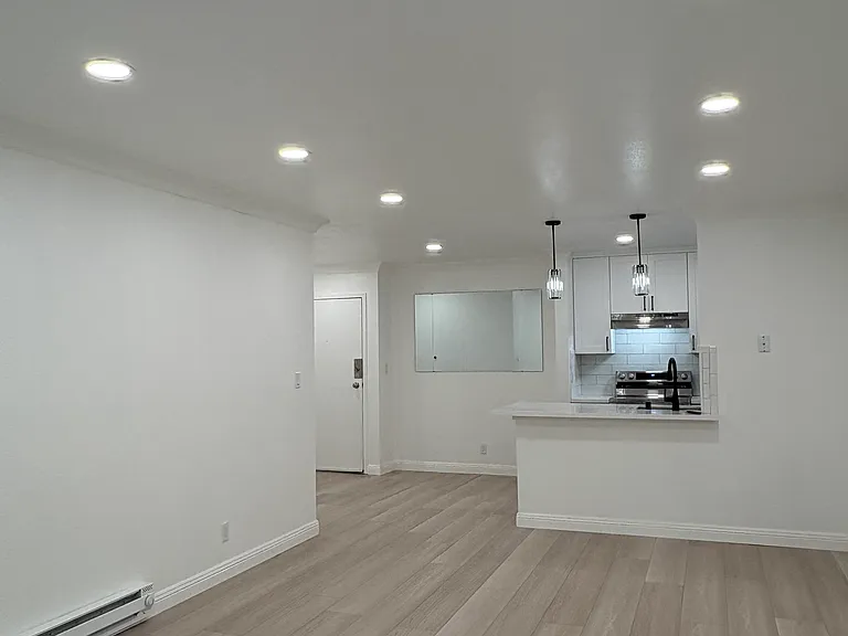 View from the living room towards kitchen. Also shows the LED dimmable recessed lighting and pendant lights over the breakfast bar.