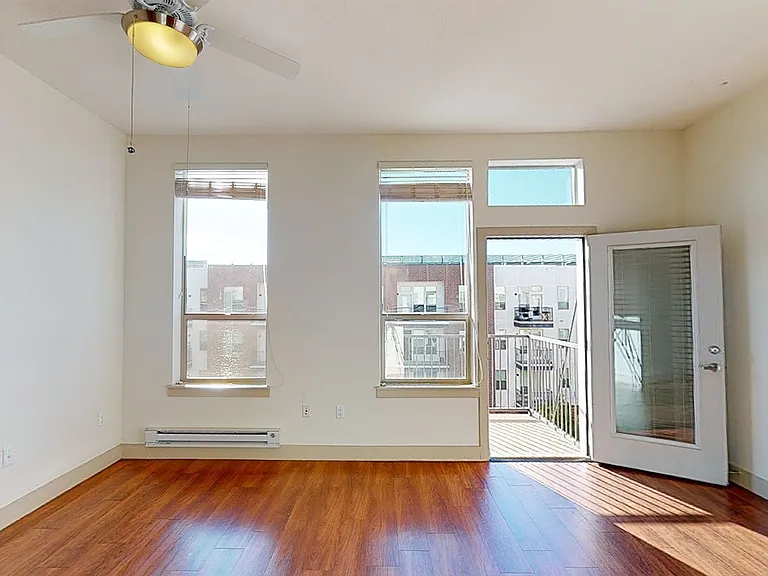 Apartment living room with wood-style flooring.