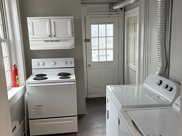Washer/dryer in unit, back to right is small panty area