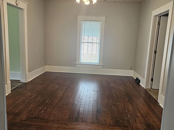 Dining room opens from Living room. The door to the left leads ot the kitchen. Door to the right leads to the carpeted bedroom and half bath.