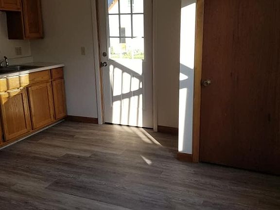 View of kitchen/front entry door and storage closet