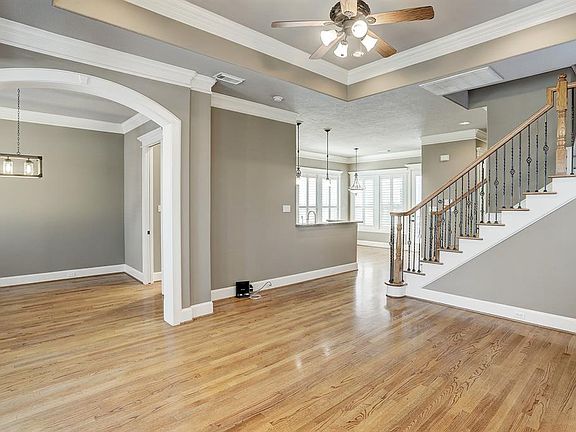 Freshly painted interior with gleaming hardwood floors. To the left of the entry is the spacious dining room with bay windows, which flows in to the kitchen. To the right is the living room.