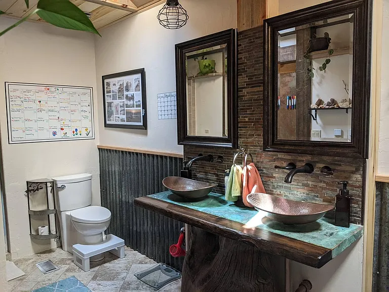 Upstairs shared bathroom with double sinks, walk-in shower