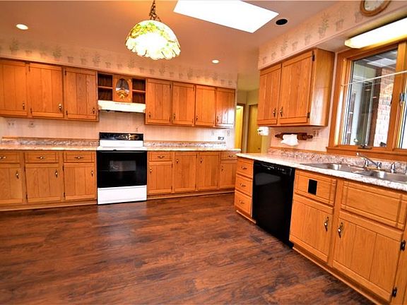 Bright kitchen with natural light from the skylight, new counter and flooring.