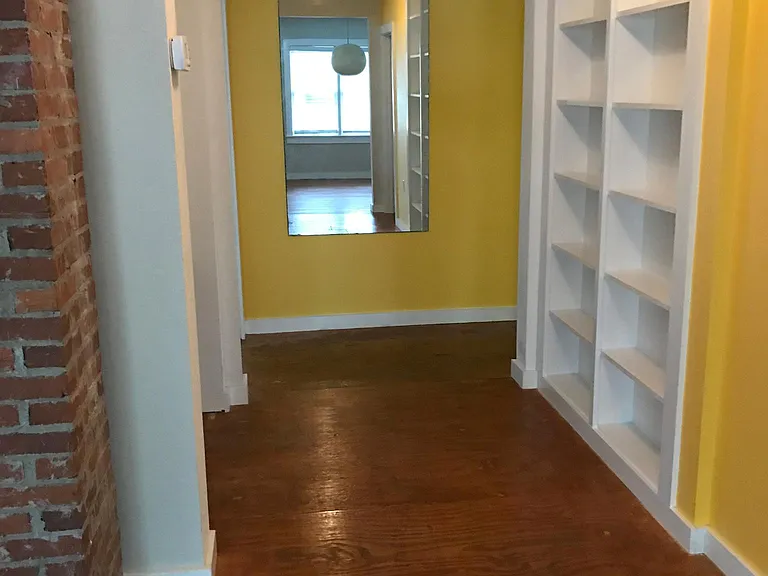 Hall wth built-ins leading to master bedroom, guest bath, and laundry room