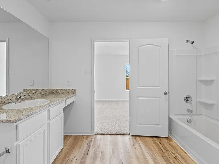 The master bedroom features a spacious vanity.