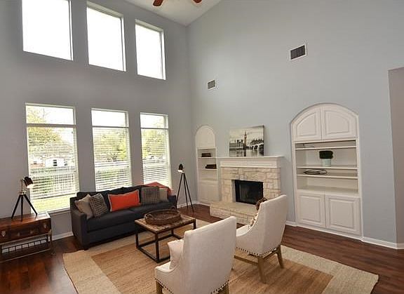 A two-story wall of windows, stone fireplace and dual built-ins are just a few of the amazing attributes of this incredible home.