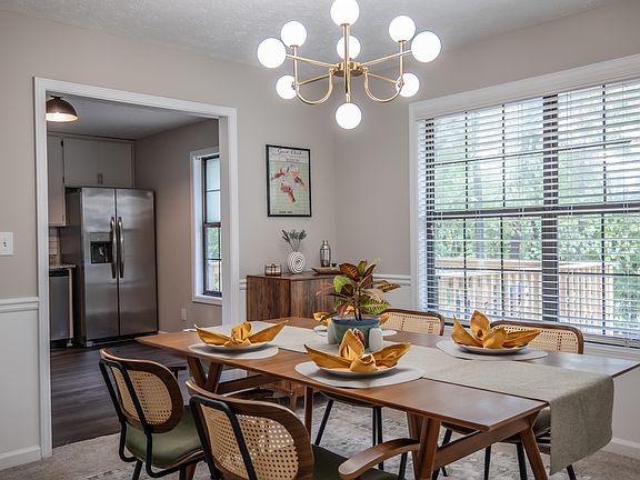 The open and welcoming dining room has been recently renovated with a stunning West Elm dining set, custom artwork, and personal touches, adding a touch of elegance and warmth to the home.
