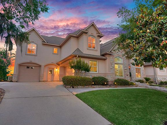 This stucco and stone home sits up high on an over-sized lot in the Estates of Bentwater.