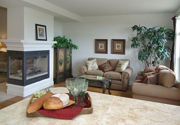 Hearth room adjoining kitchen with 3 sided fireplace