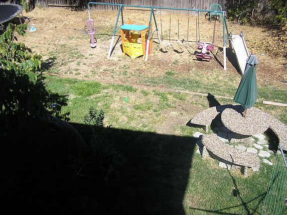 Huge backyard with swing, trampoline and pool.