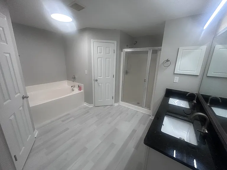 Master bathroom with shower, separate tub, 2 large closets