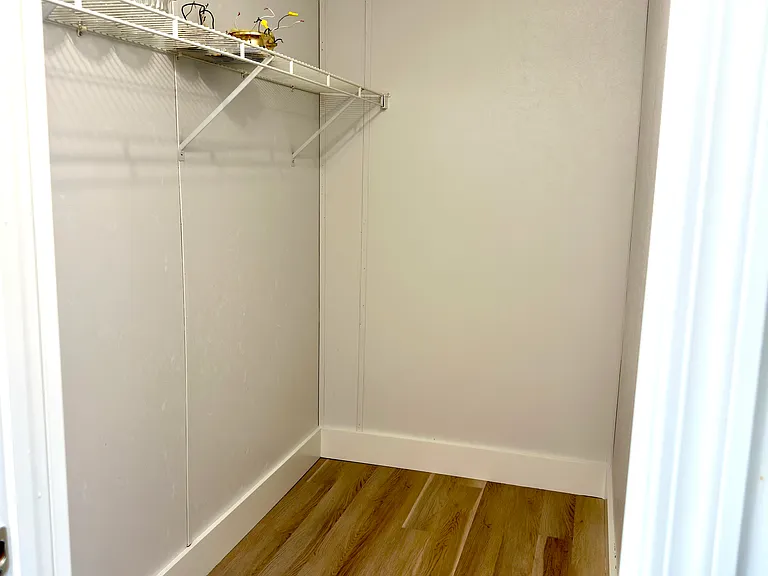 One of the two primary bedroom walk in closets