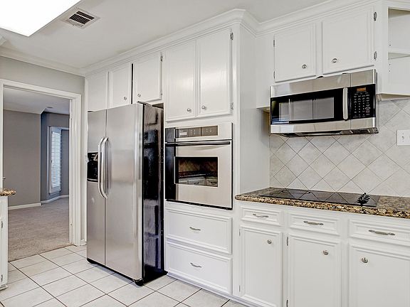 Kitchen with refrigerator, oven, gas range, and microwave installed in 2020.