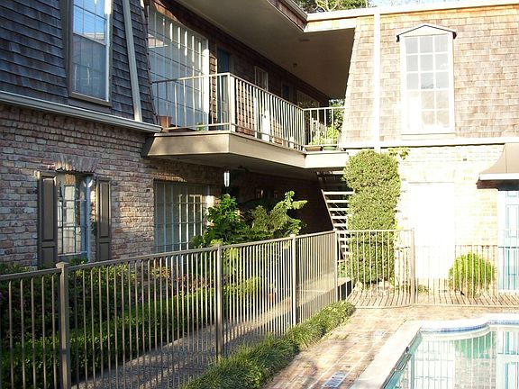 View of second level unit and heated pool from ground level.