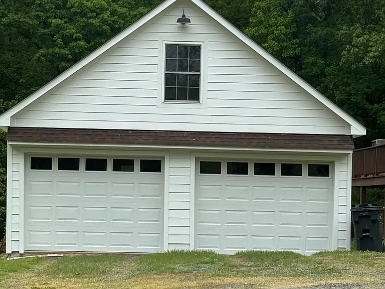 Two car garage with new siding and doors.