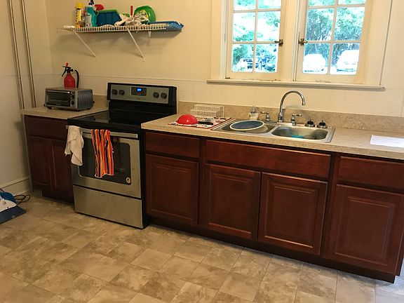 Kitchen, newly renovated in 2020 with new cabinets, stove, sink, flooring and full size refrigerator/freezer