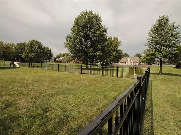 Beautiful trees, distant neighbors and a partial lakeview in the distance