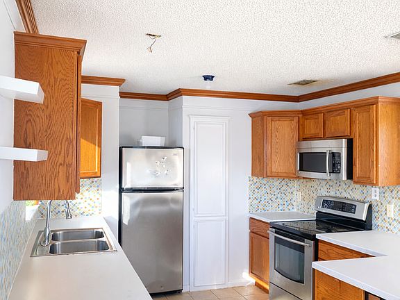 Kitchen is spacious and freshly painted