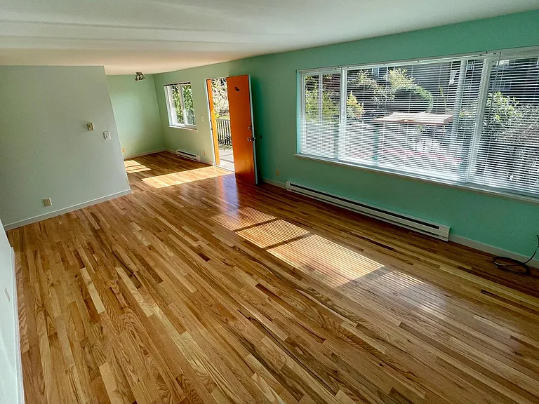 Apt 5. Living room with new hardwood floors, great light.