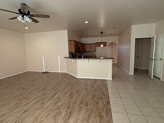 Living area looking into kitchen / laundry room off to right then step down into garage