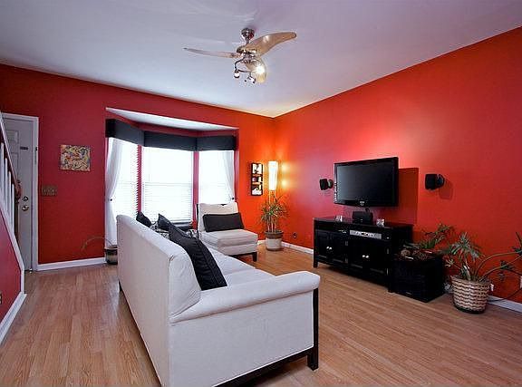 A beautiful bay window with custom window treatments offers plenty of sunlight