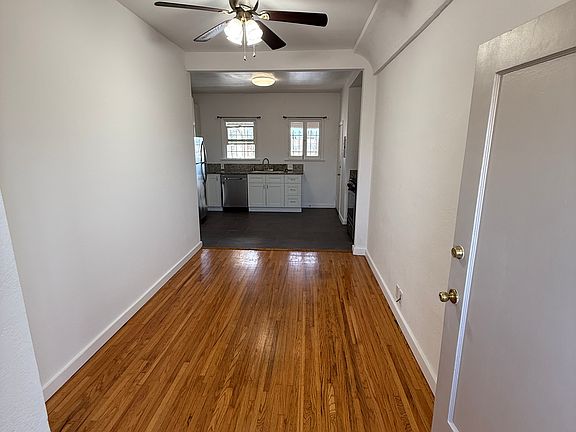 Living Room with Ceiling Fan Light, Central A/C and Heat, and Newly-Refinished Hardwood Floors