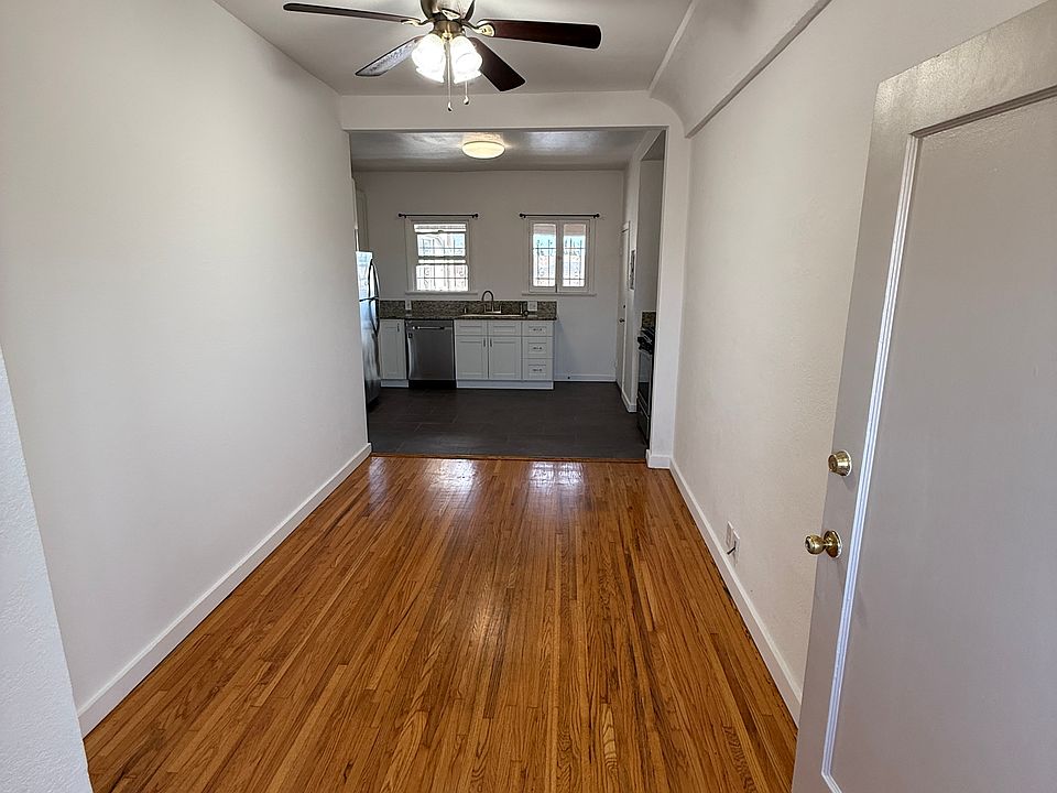 Living Room with Ceiling Fan Light, Central A/C and Heat, and Newly-Refinished Hardwood Floors