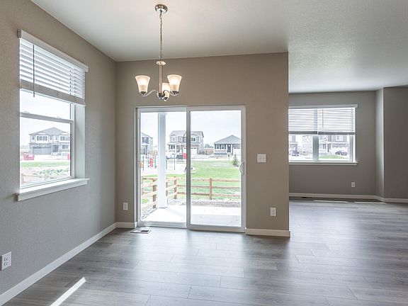 Dining area and adjacent living room with sliding door backyard access