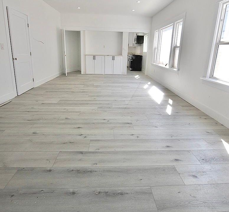 Bright and airy living room! New floors, recessed lighting, and plenty of storage!