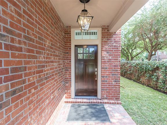 Private gated entry with updated walnut door with leaded glass and satin hardware. Privacy fence is located along perimiter with ivy charm.