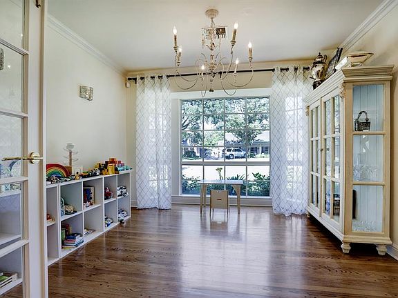 The current owners have this area as a playroom with a large bay window, and beautiful lighting fixtures