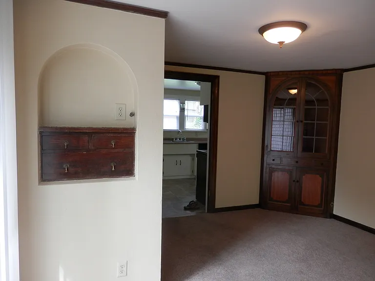 From the office nook into dining; built ins in dining room and entrance to the spacious kitchen; old flooring see wood flooring in earlier picture