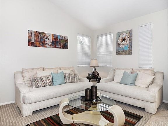 This view focuses on the light and bright living room.