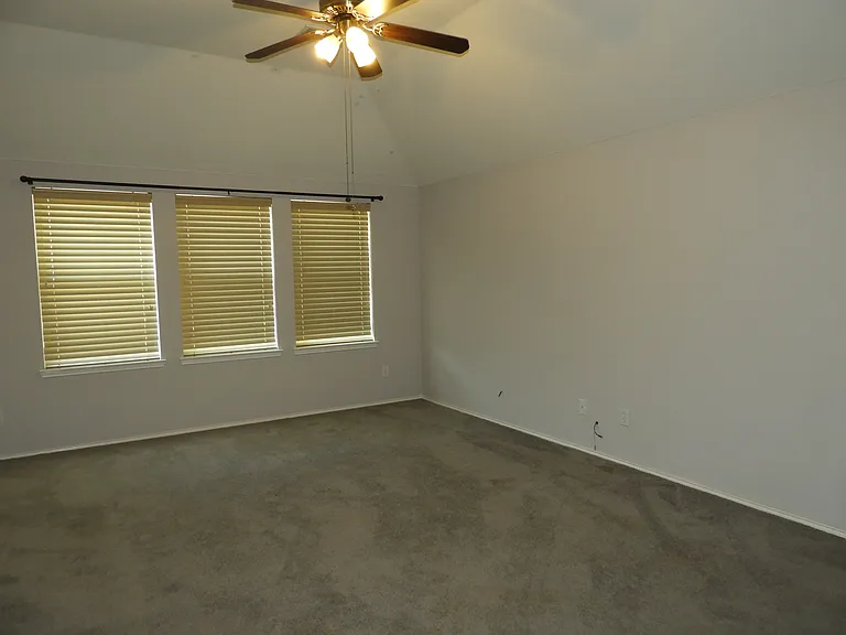 Spacious Gameroom with high ceilings and ceiling fan.