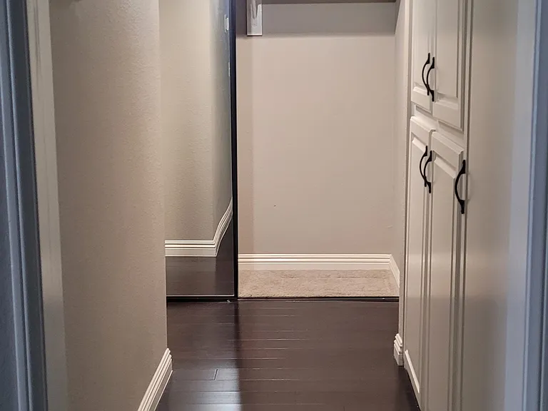 Hallway with linen closet and hallway closet view