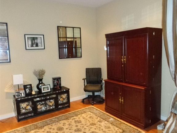 Den with hardwood floor