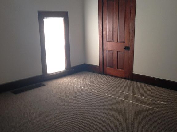 Upstairs front bedroom. LARGE room with hanging closet and shelves in the closet door pictured on the right. carpet. ceiling fan