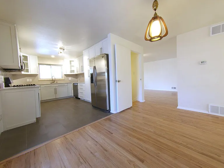View from dining area of kitchen and into living room.
