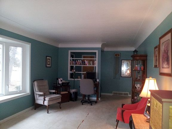 Freshly paint living room with built in shelving at entrance