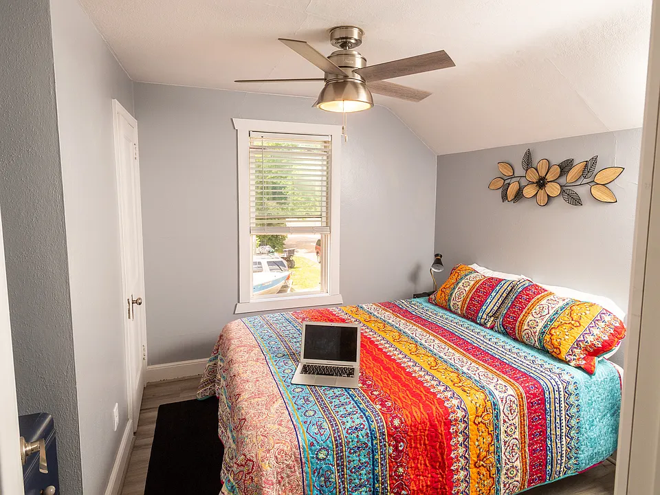 Queen size bed with large closet and dresser.