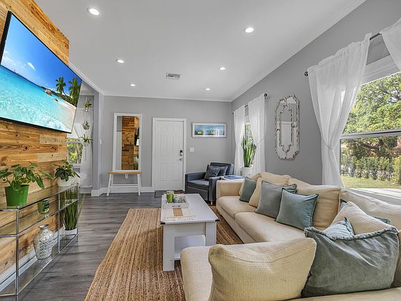 Very comfortable cloud couch and big screen smart TV in living area