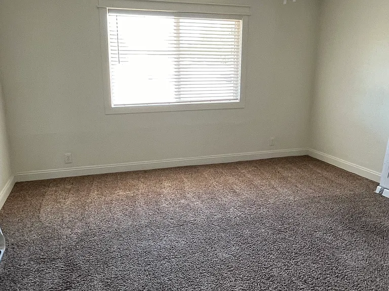 2nd bedroom with new fan, window and blinds.
