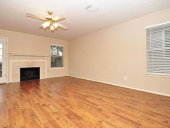 Huge living room with wood flooring and gas log fireplace