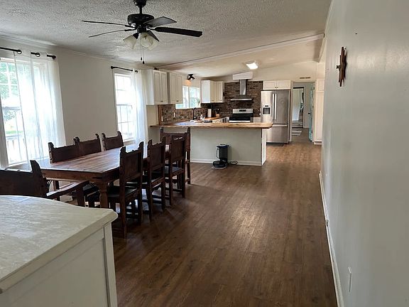 View of dining room and kitchen from guest bedroom hallway